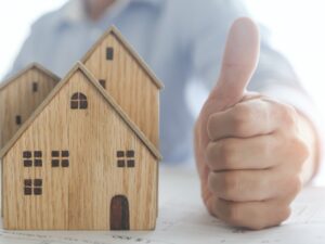 thumb-up-hand-of-bank-agent-confirm-on-home-or-resident-successful-and-ready-real-estate-concept