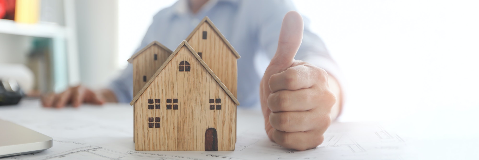 thumb-up-hand-of-bank-agent-confirm-on-home-or-resident-successful-and-ready-real-estate-concept